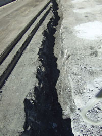 Every year since the 1970s, the eastbound lane has subsided a few inches during springtime snow melt. This fissure was found after asphalt was removed for repairs in summer 2012. 