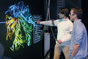 As part of NSF's CAVE project, scientists explore molecular structures inside a 3D visualization facility (courtesty: Wolfgang Bluhm)
