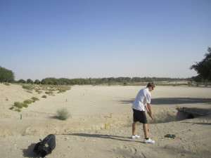 Doing my best on one of Abu Dhabi's sand golf courses