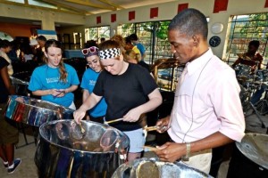 Jamaican tenor player Jahnoy Davis provides guidance as Mines students (L to R) Jaimie Stevens, Christina Ochoa, and Krista Horn try their hand at steel drums. Horn will be the first Mines student to graduate with a music technology minor. 