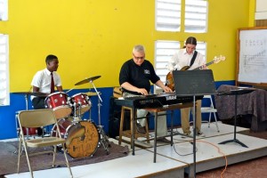Mines music program director Robert Klimek (center), Mines student Nicklaus Smith (right), and student drummer Clive Linton from the Alpha Boys School in Jamaica demonstrate a jazz piece for Alpha students. 