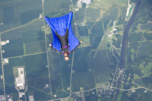 An above shot of Mines alumnus Derek Parks spreadeagled with his wingsuit stretched tight.