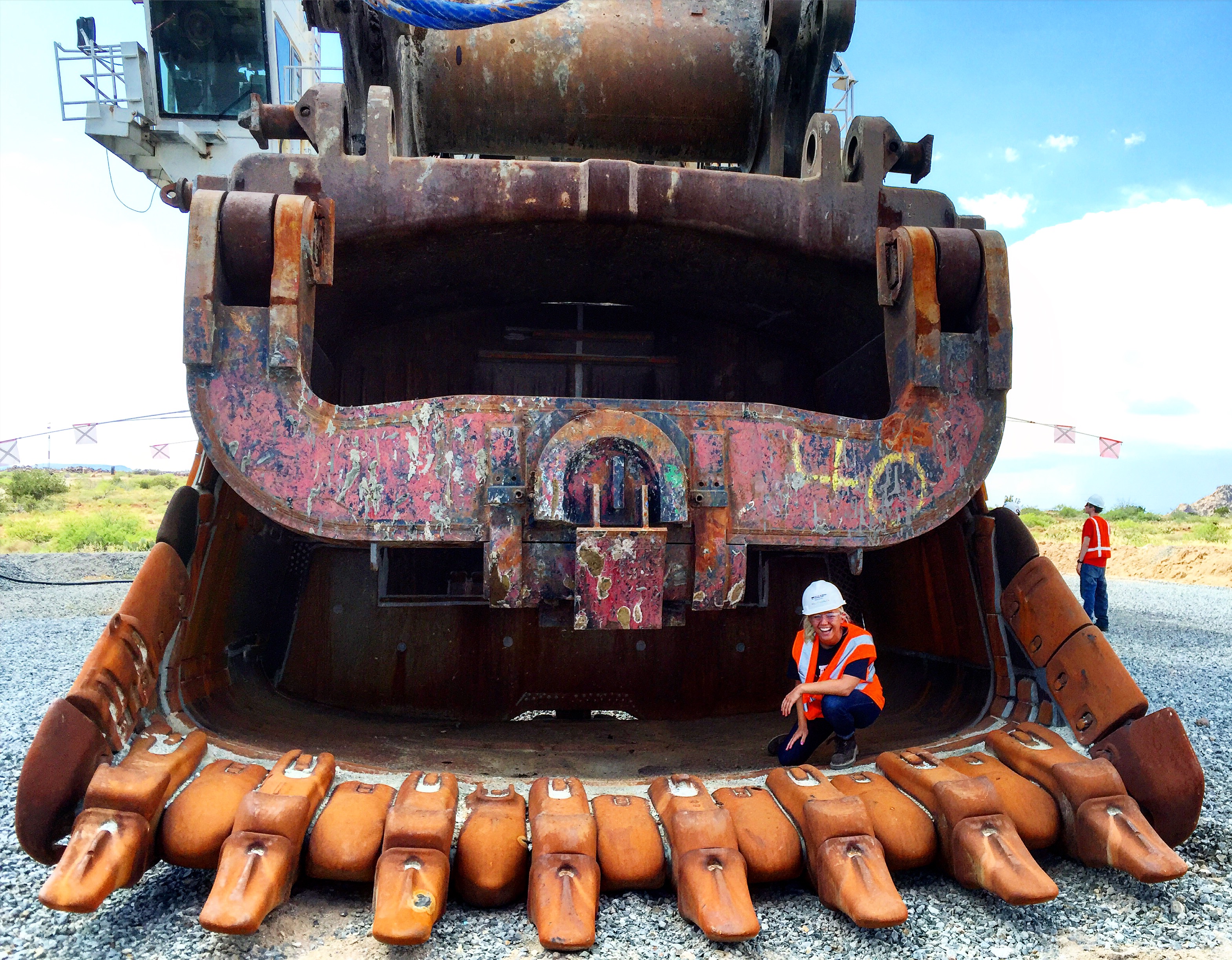 Haley Whalen crouches on a shovel used to load ore into haul trucks.