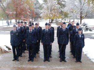 Air Force ROTC cadets stand in four rows.
