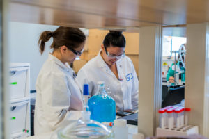 Female students work in the radiochemistry lab