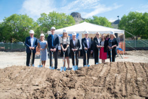 Mines President Paul C. Johnson and several other stakeholders hold shovels in the dirt where a new residence hall is to be built on campus