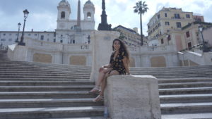Skye Kim sits on steps in Spain