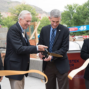 Joe Coors and Paul Johnson cutting ribbon at opening of CoorsTek Center