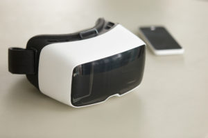 VR headset and smartphone on desk, virtual reality mobile techno