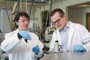 Chris Higgins and a woman student working in a lab