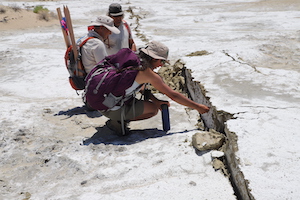 USGS scientists examine a fissure caused by the 6.4 and 7.1 magnitude earthquakes that hit Ridgecrest, Calif. in July 2019.