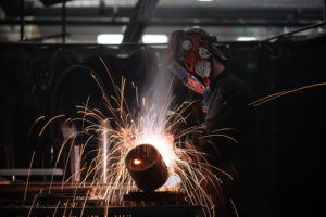 Student welding with sparks