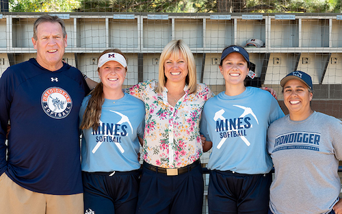 Current Oredigger infielders Hannah Roberts (second from left) and Sidney Wilson (second from right), Kerry Siggins ’01 (center), Head Coach Mike Coutts and Assistant Coach Barb Duran.